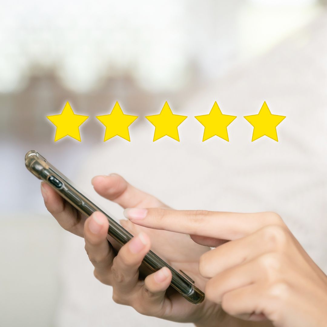 Person holding phone reading five star reviews for Prairie Bliss Massage
